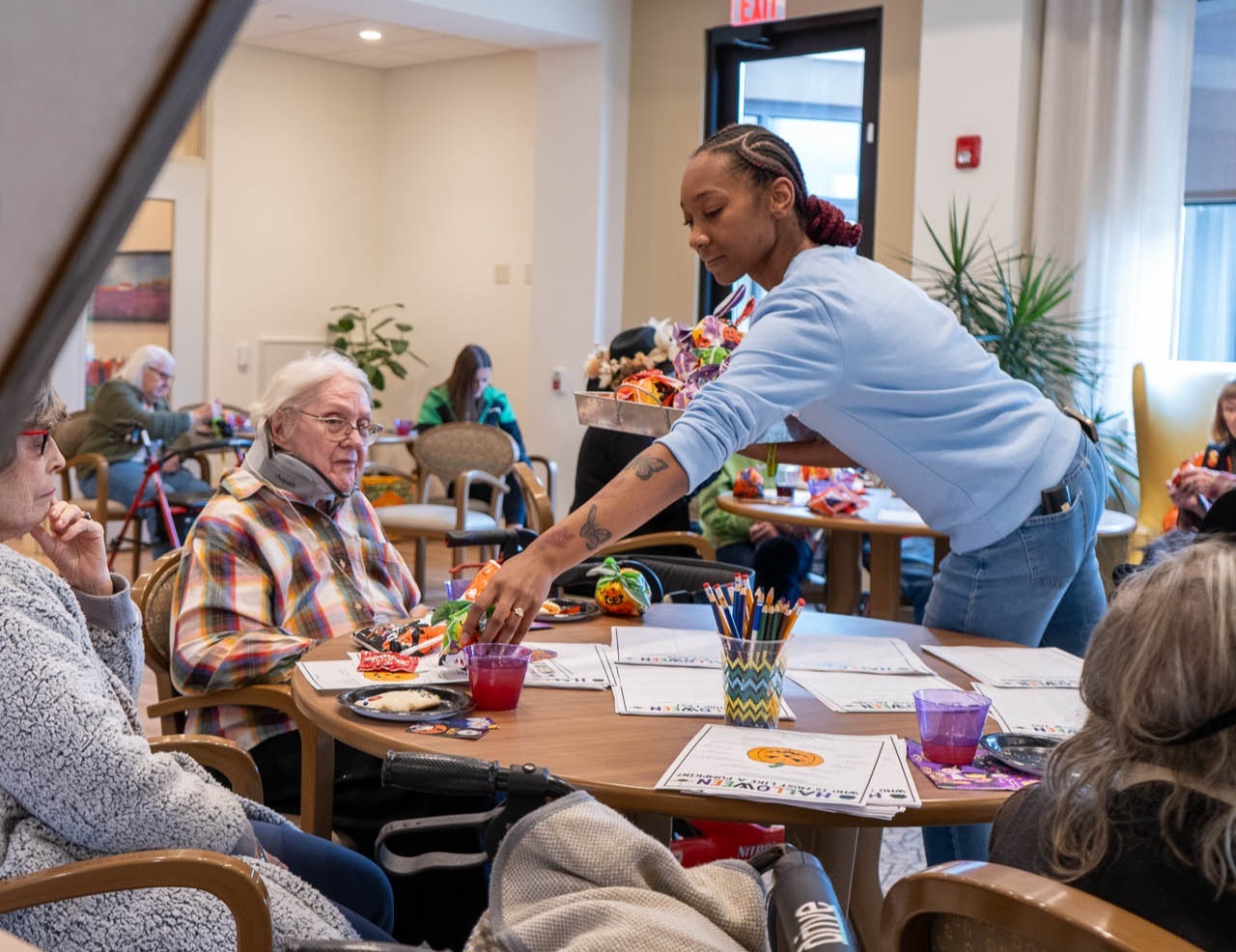 Woman running activities for people around a table