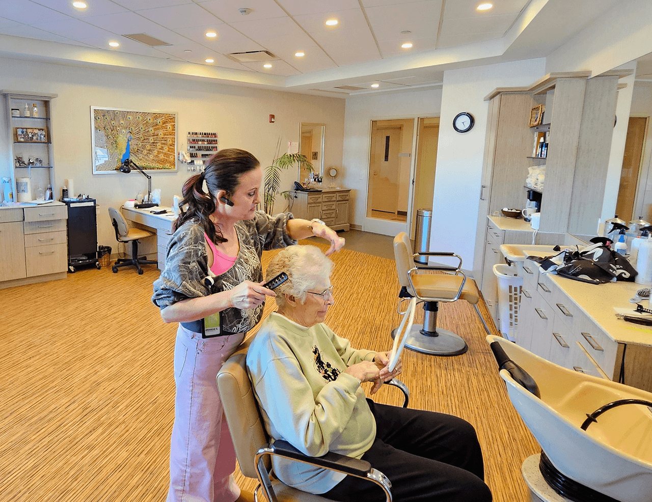 Woman cutting hair in the TLC hair salon