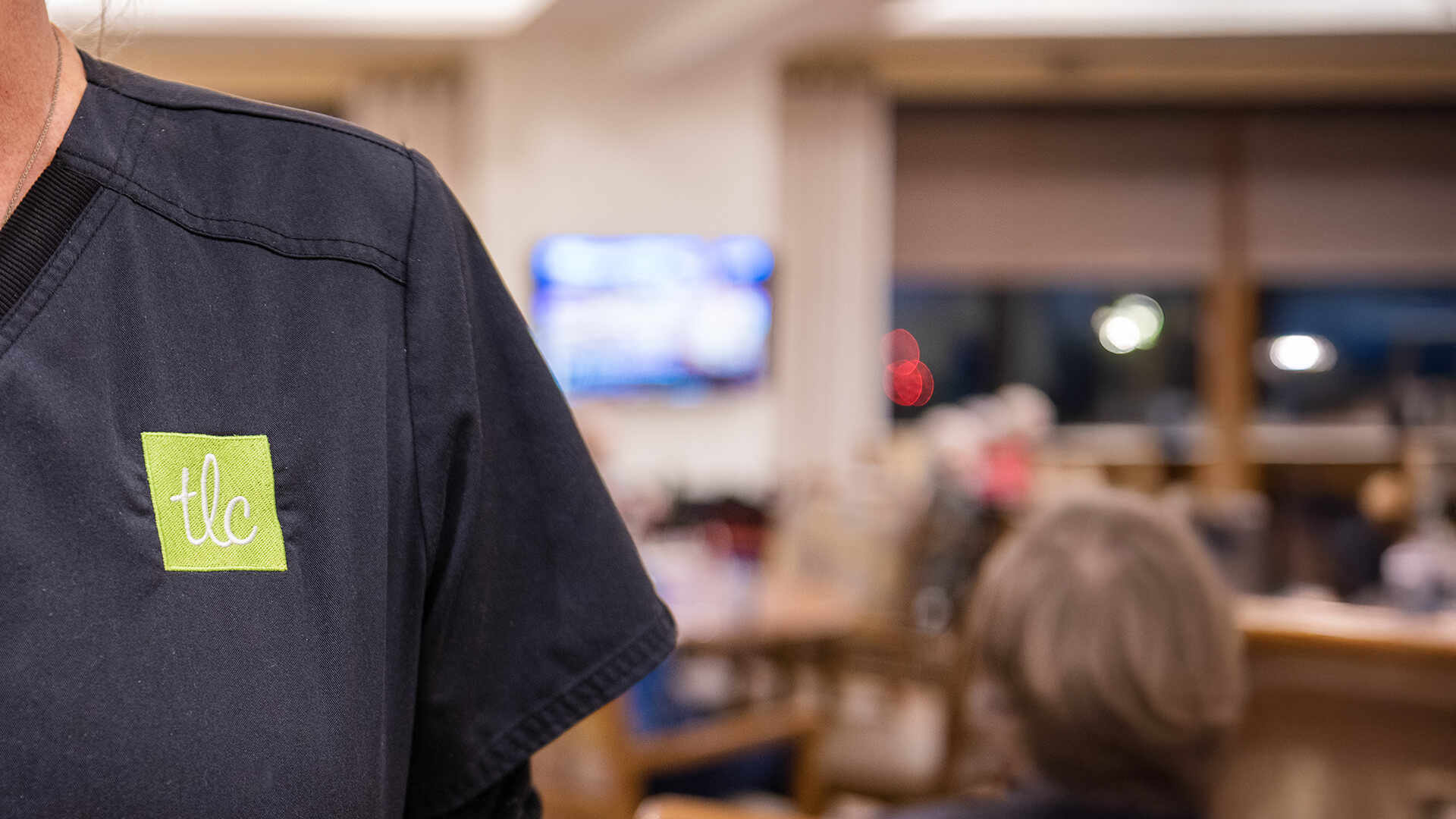 TLC Employee with branded shirt