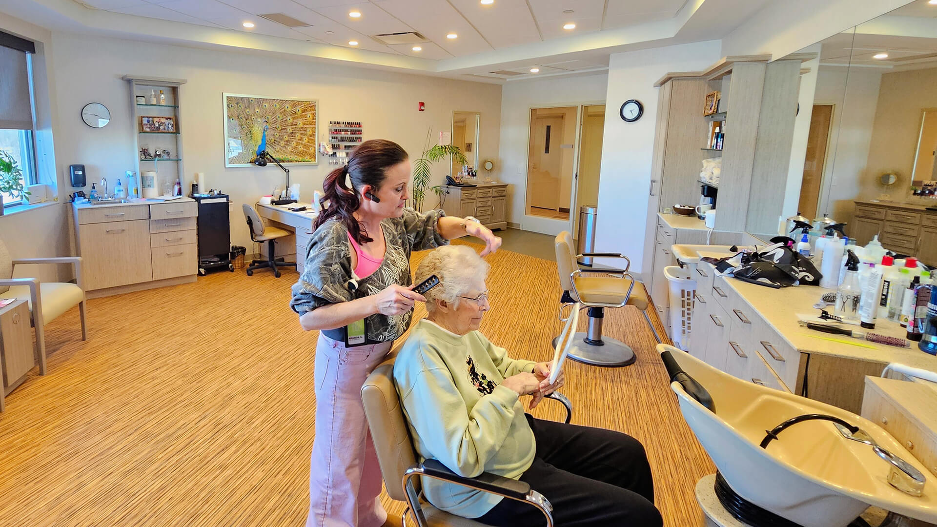 Woman getting her hair styled in the TLC hair salon