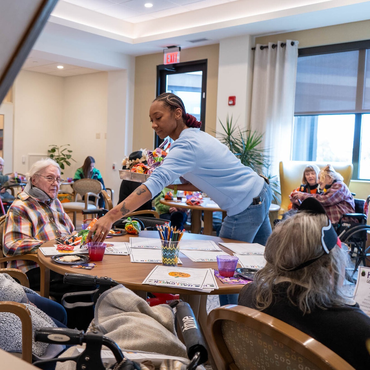 Woman running activies for people around a table