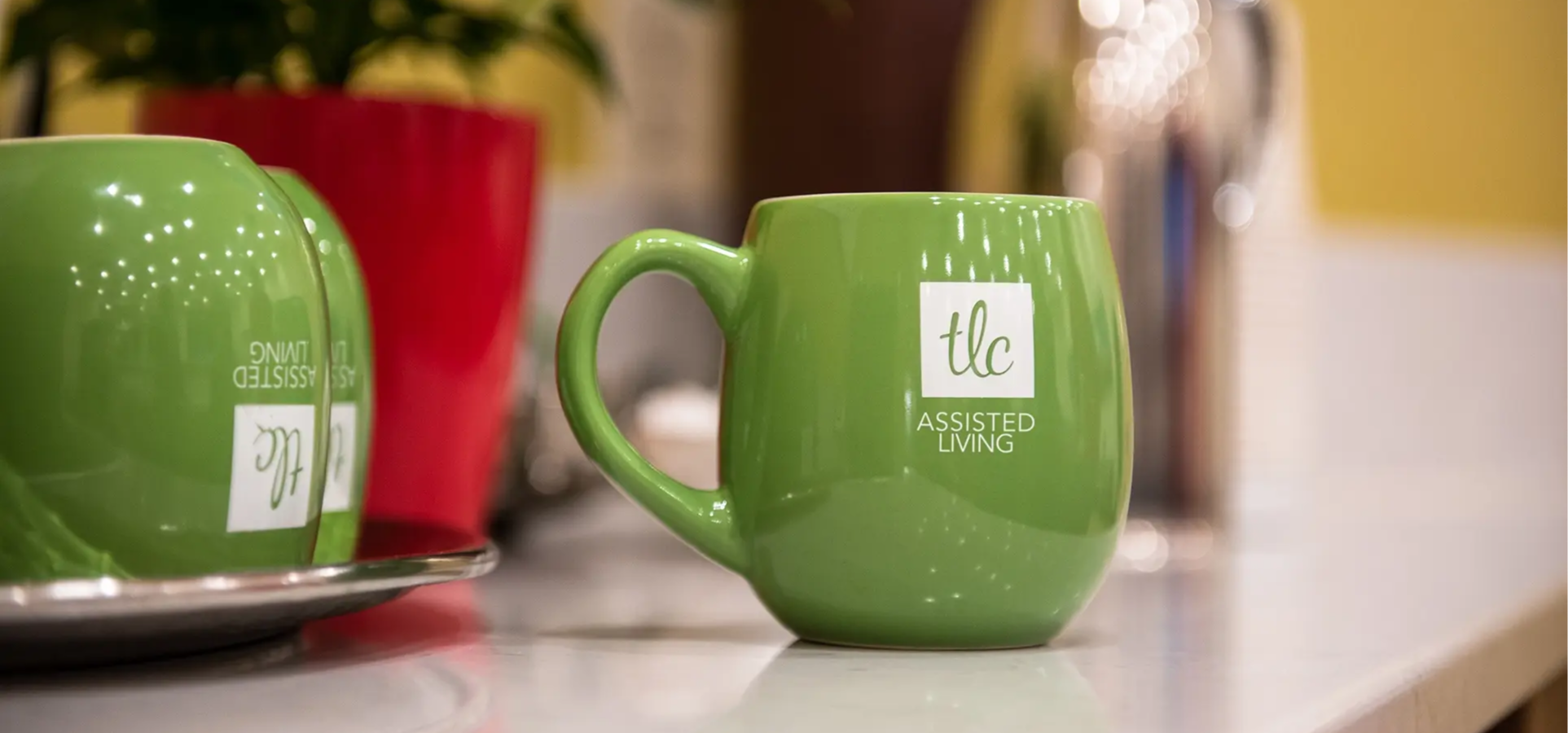 TLC Coffee Mugs on a Counter
