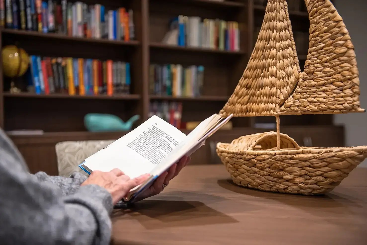 Person reading a book in the TLC library